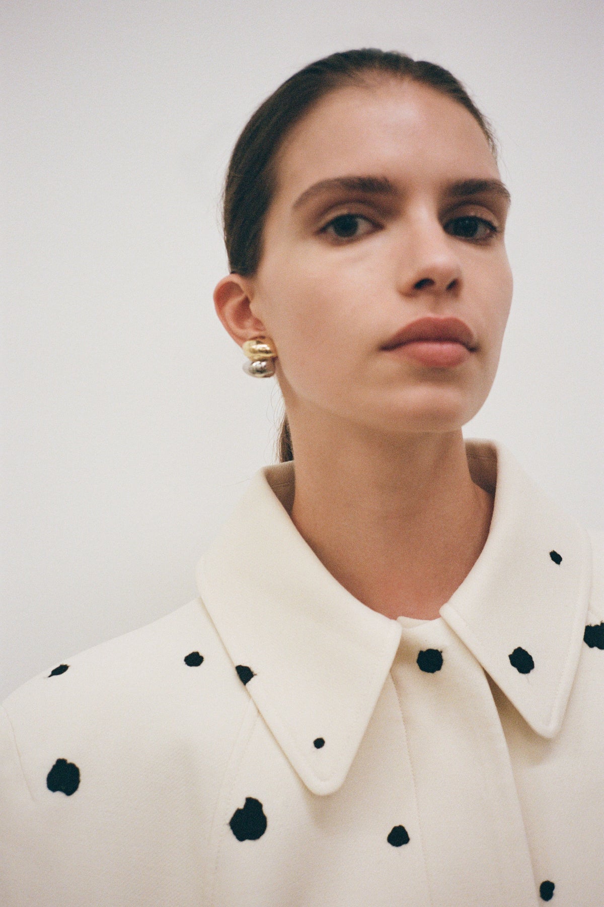 Styled image CAMILLA AND MARC Koa Earrings in sculptural two‑tone 18k gold and rhodium plating.  