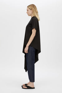 Side view CAMILLA AND MARC Clarity draped oversized asymmetric tee in black with raw hemline and internal french seams.