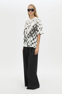 Three-quarter view CAMILLA AND MARC Asper Print Tee in Soft White with oversized short‑sleeve silhouette and printed artwork. 