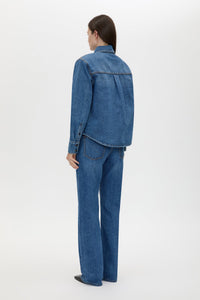 Back view CAMILLA AND MARC Caden Denim Shirt in Dark Classic Blue with shoulder pads and an embroidered monogram.