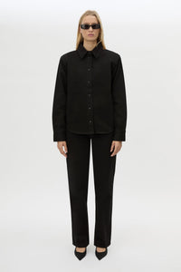 Front styled view CAMILLA AND MARC Caden Denim Shirt in True Black with shoulder pads and embroidered monogram detailing.