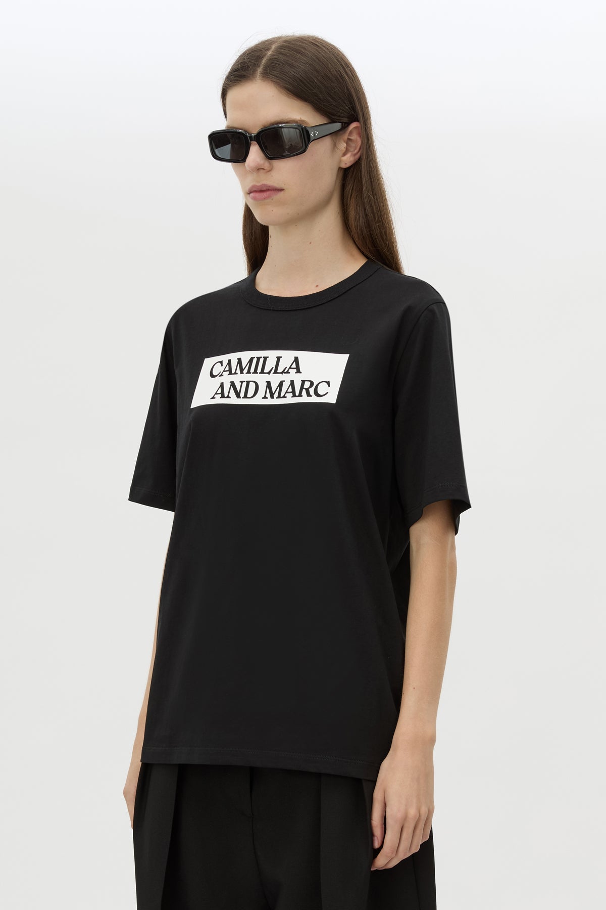 Cropped view CAMILLA AND MARC Carmont Graphic Tee in Black with white graphic logo.