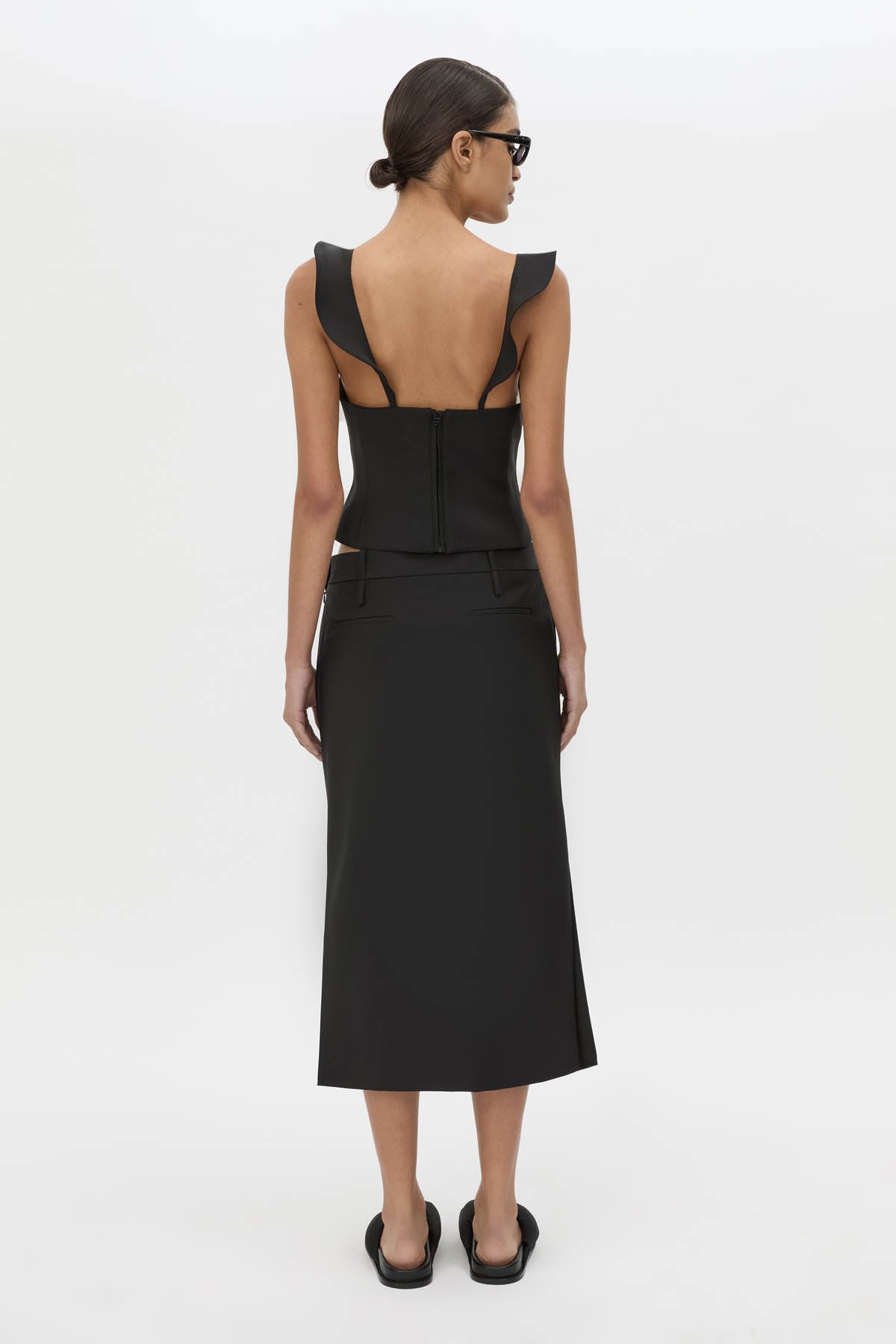 Back view CAMILLA AND MARC Chiaro Midi Skirt in black with low‑rise fit.