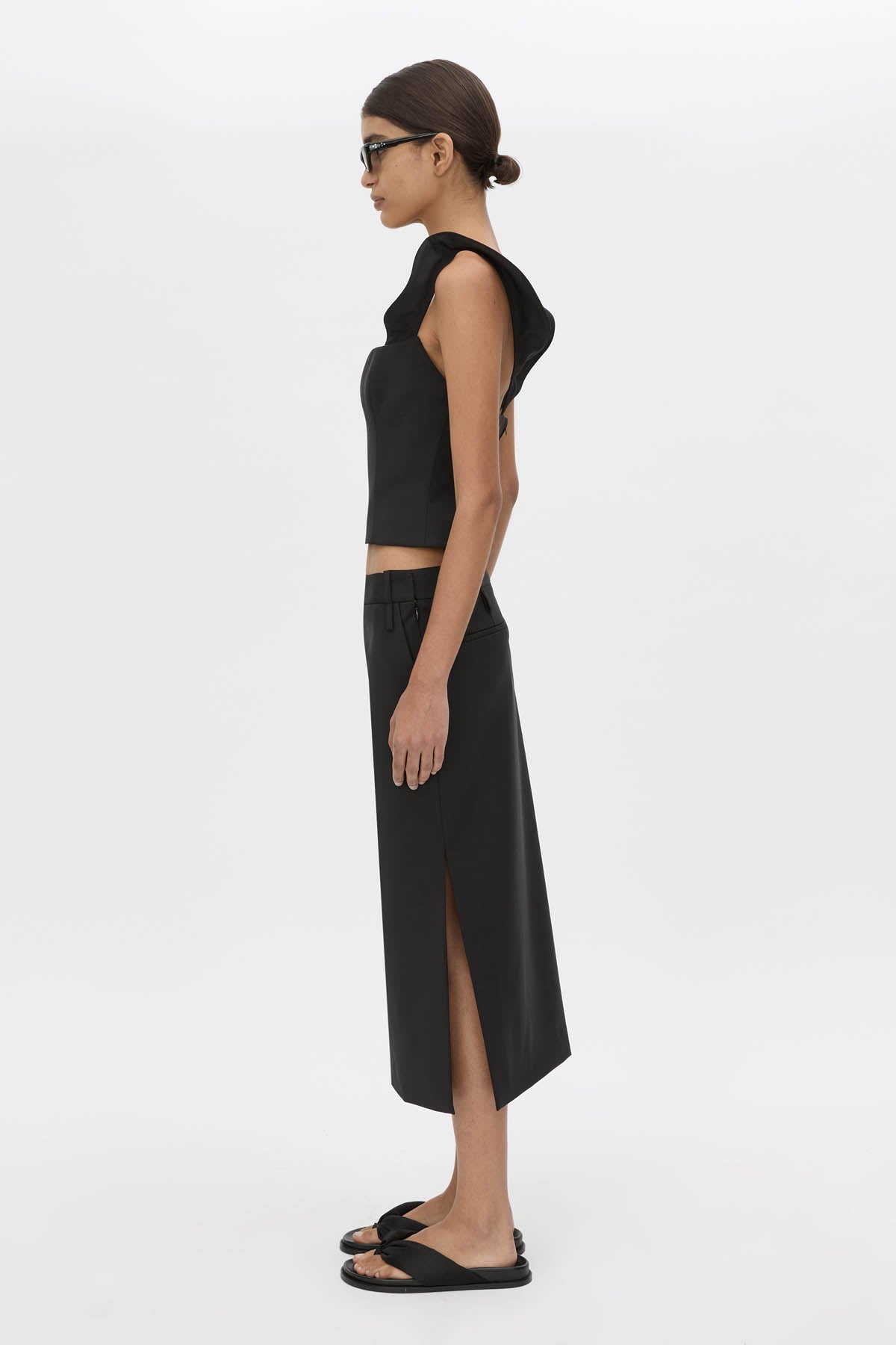 Side view CAMILLA AND MARC Chiaro Midi Skirt in black with low‑rise fit.