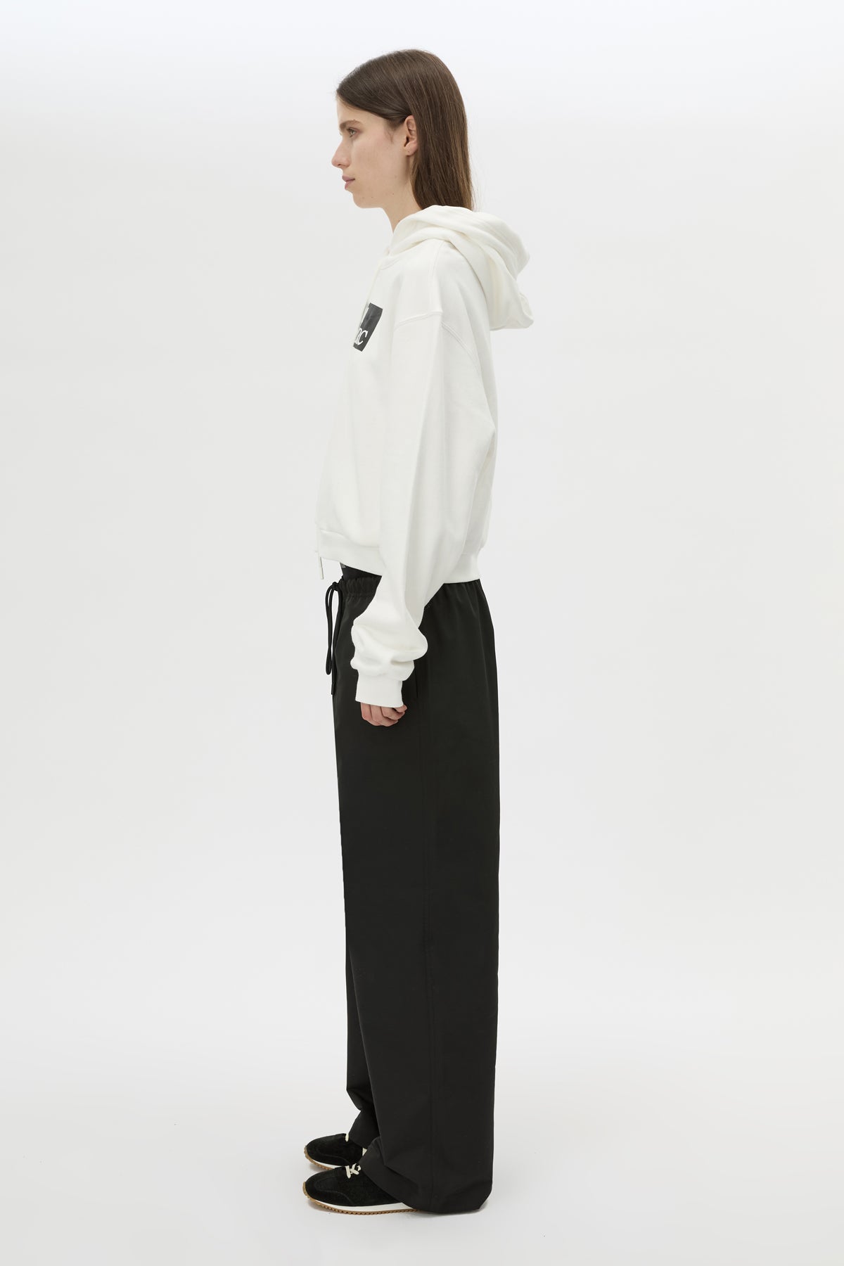 Side view CAMILLA AND MARC Dia Elastic Detail Pant in Black with logo detail.