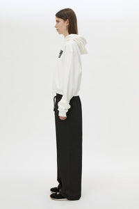 Side view CAMILLA AND MARC Dia Elastic Detail Pant in Black with logo detail.