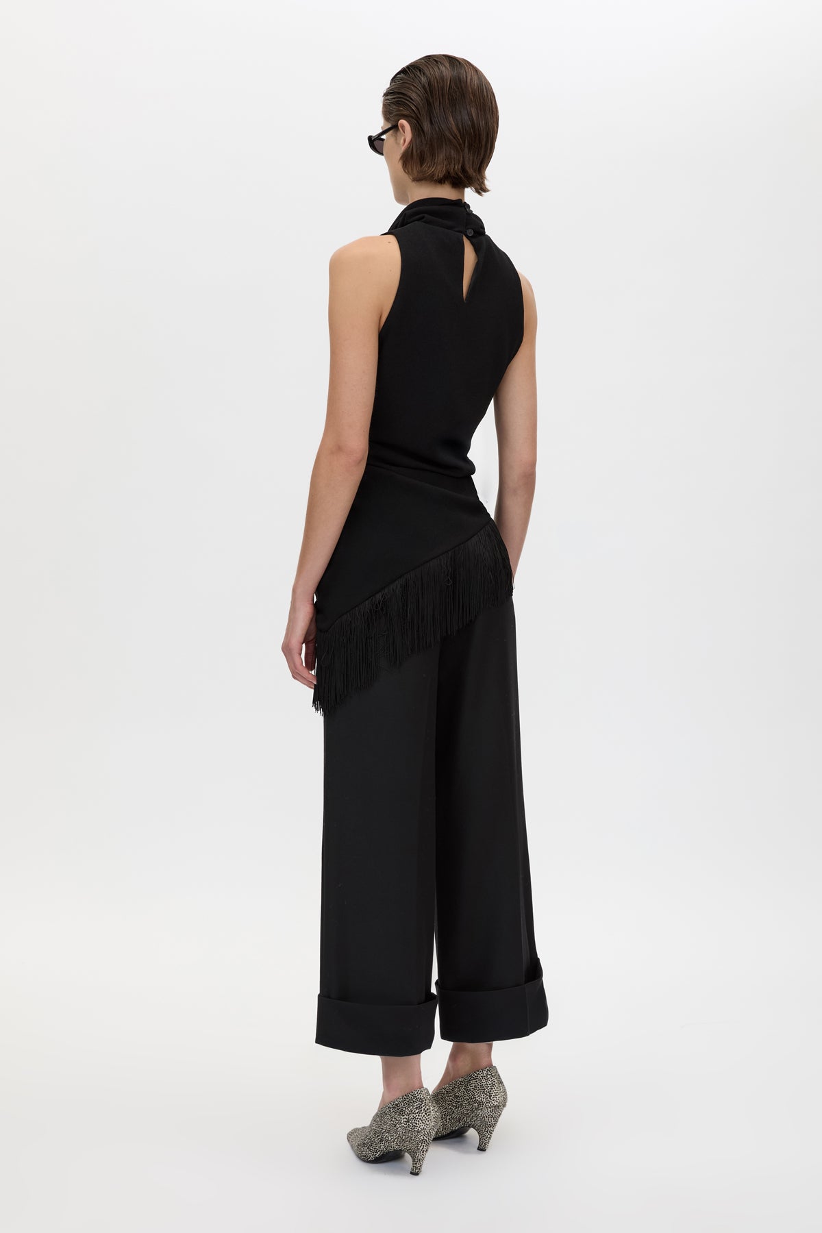 Back styled view CAMILLA AND MARC Dune Fringe Top in Black with asymmetric cut, gathered waist, high neck and fringe scarf.