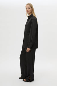 Side view CAMILLA AND MARC Ground Satin Long Sleeve Shirt in Black with collared neckline.