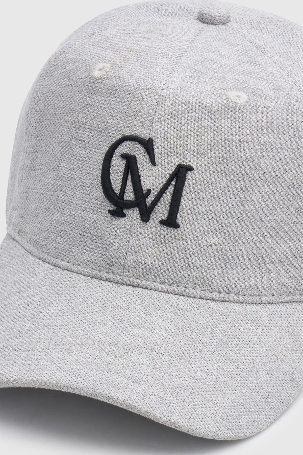 Cropped view CAMILLA AND MARC Isolde Embroidered Logo Cap in Grey Marle and black with front embroidered artwork.