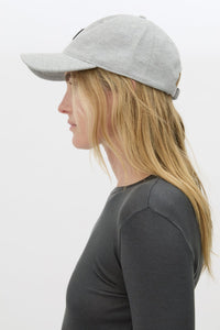 Side  view CAMILLA AND MARC Isolde Embroidered Logo Cap in Grey Marle and black with front embroidered artwork.