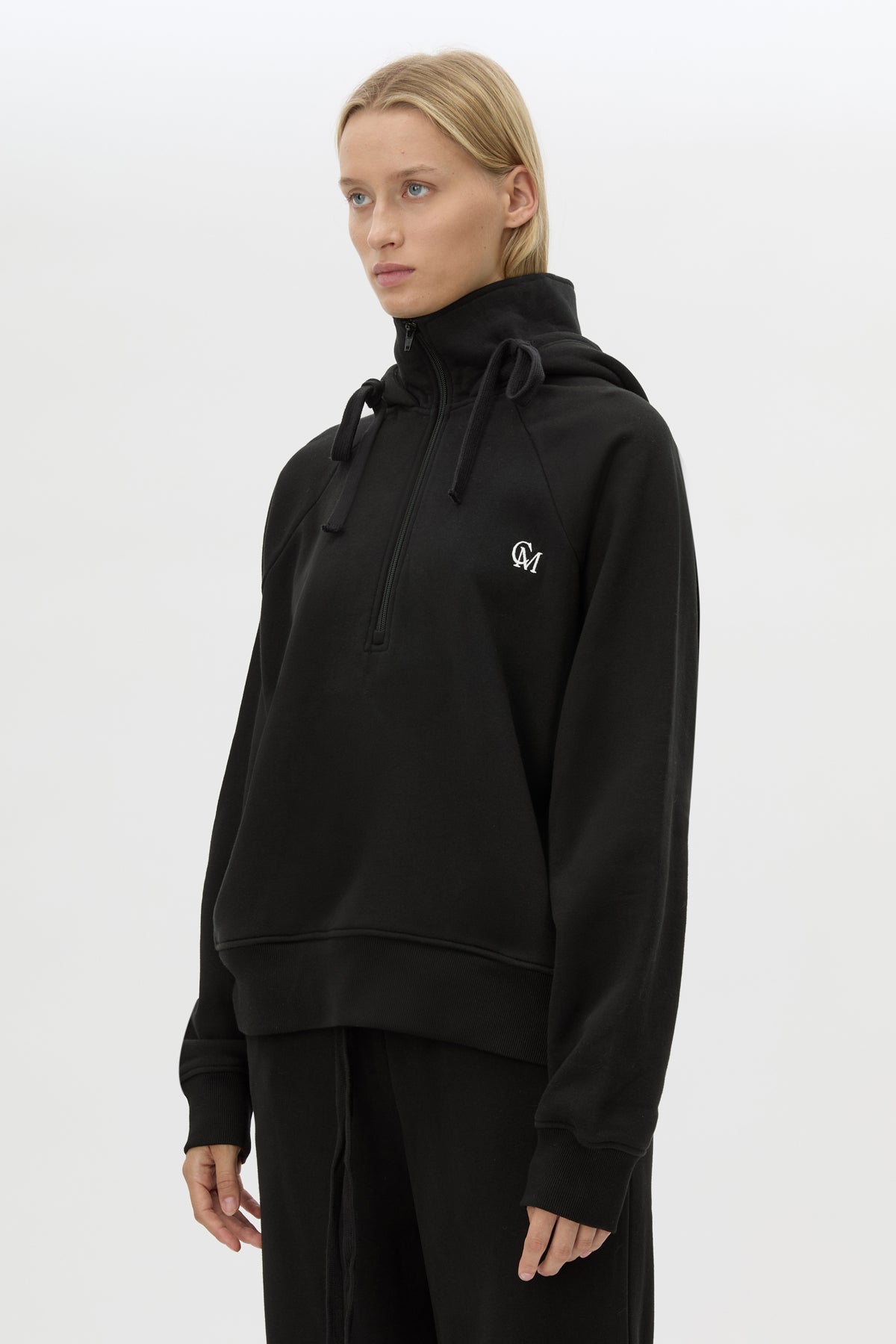 Cropped view CAMILLA AND MARC Lyra Embroidered Hoodie in Black and White with exposed quarter‑zip opening.