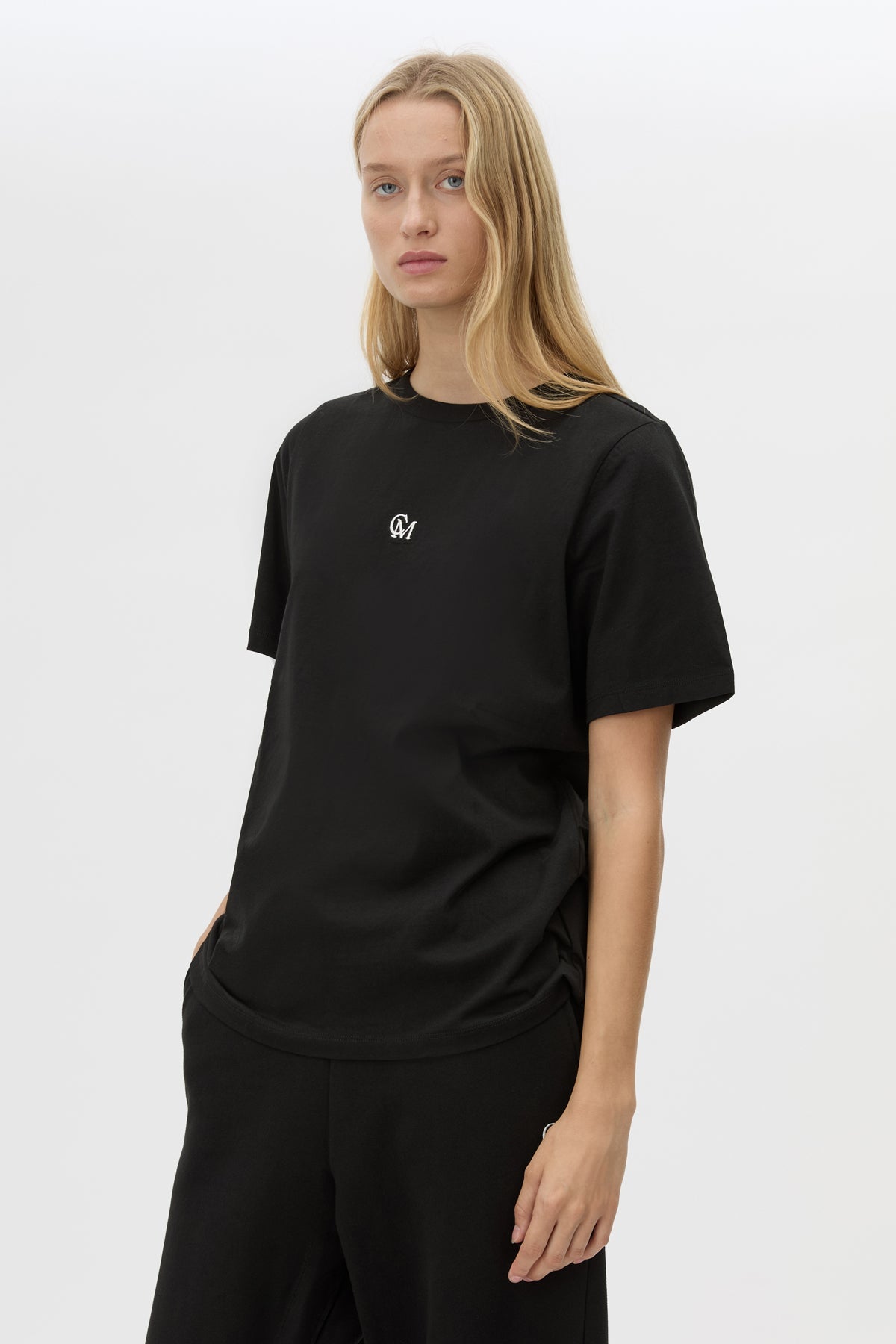 Cropped view CAMILLA AND MARC Lyra Logo Tee in Black with a 100% cotton fabrication.