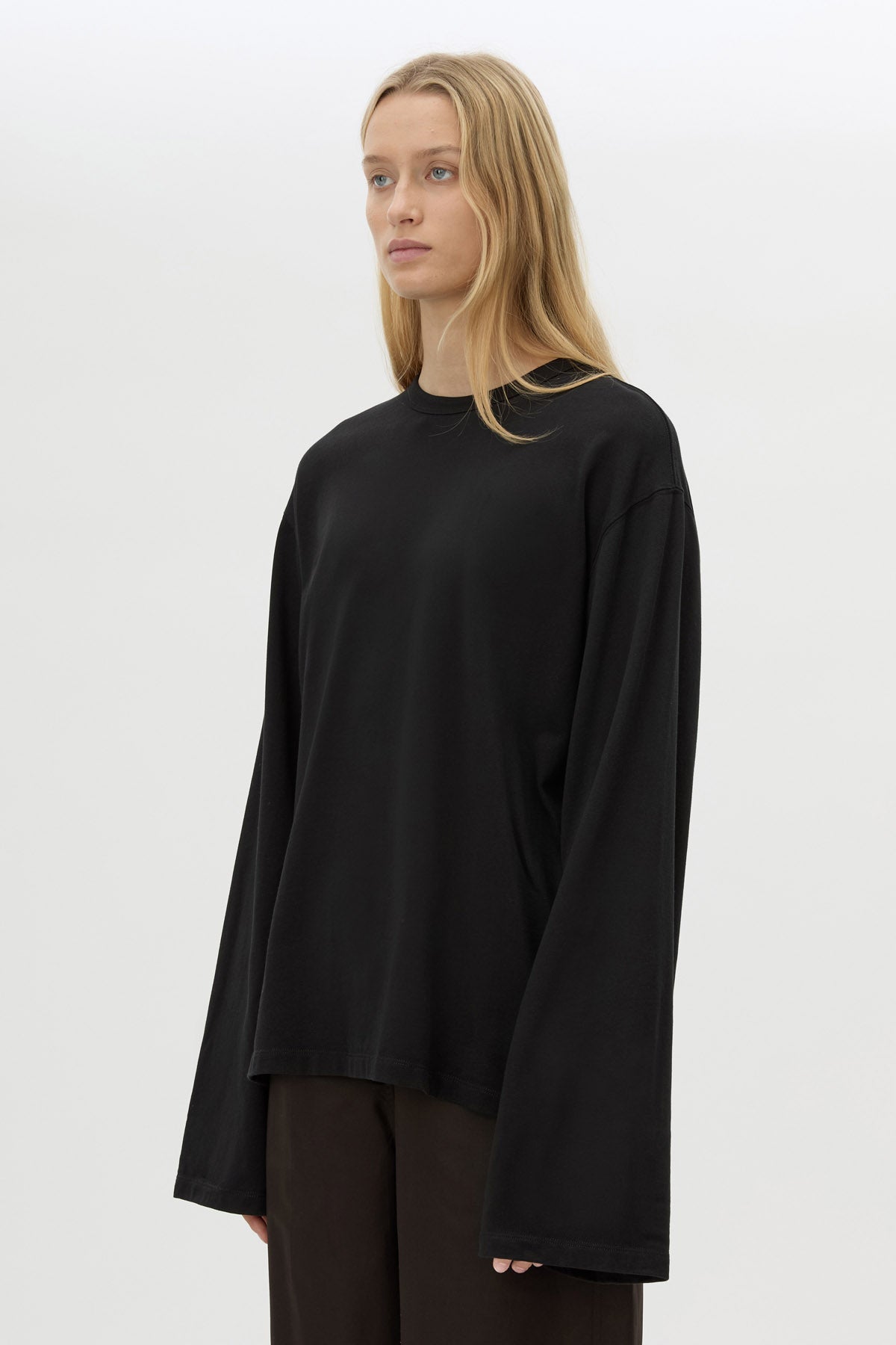 Close view with shorts CAMILLA AND MARC Peretti Long Sleeve Tee in Black with wide shaped sleeves.  