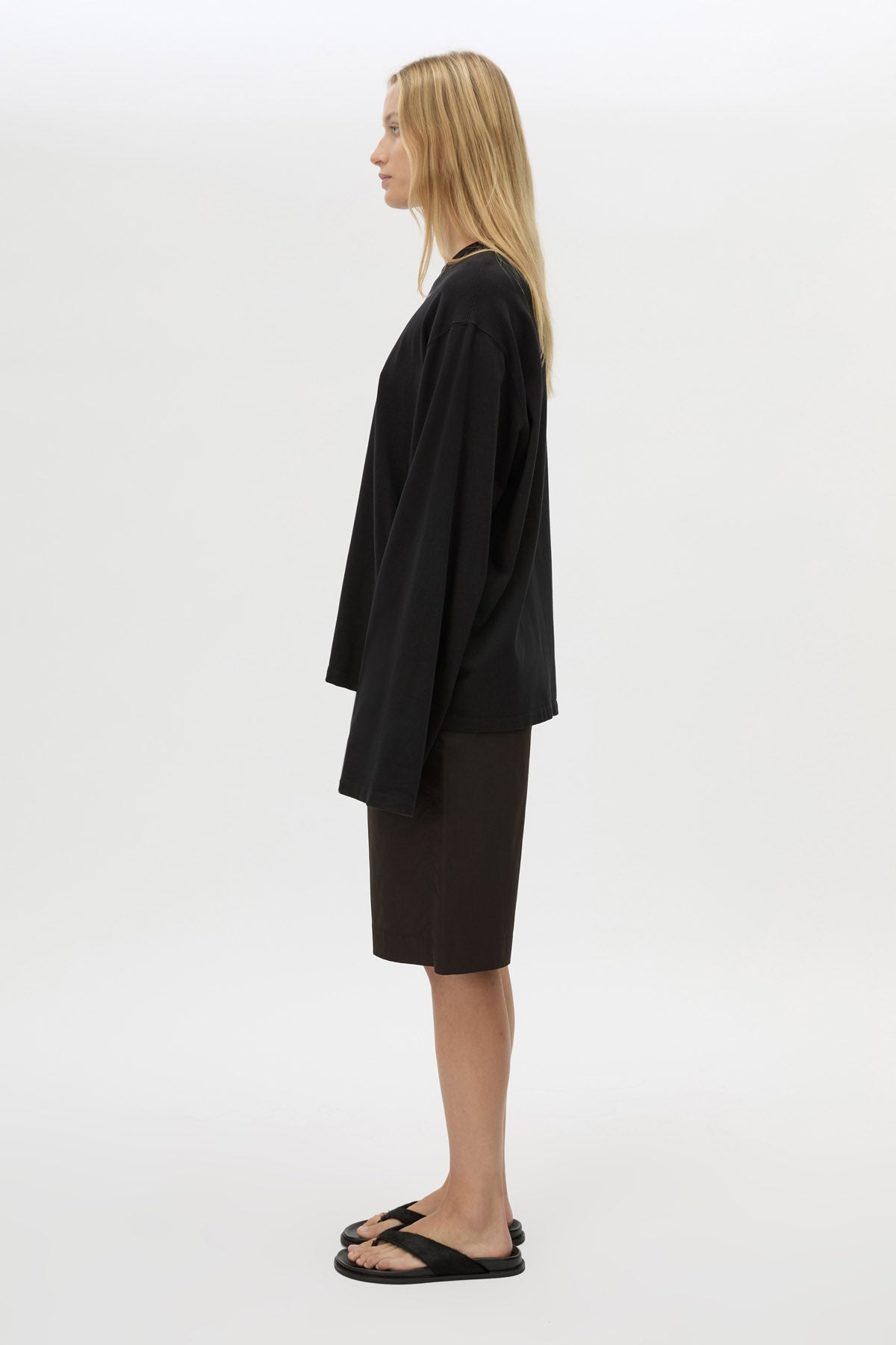 Side view with shorts CAMILLA AND MARC Peretti Long Sleeve Tee in Black with wide shaped sleeves.  