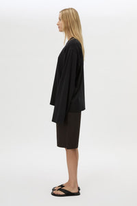 Side view with shorts CAMILLA AND MARC Peretti Long Sleeve Tee in Black with wide shaped sleeves.  