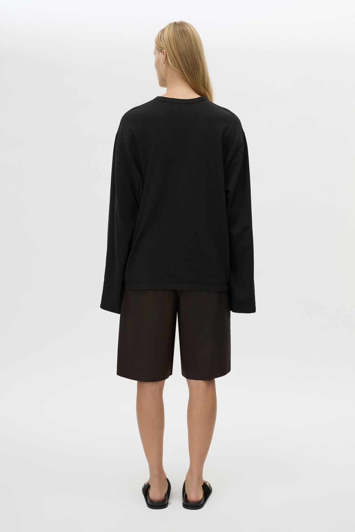 Back view with shorts CAMILLA AND MARC Peretti Long Sleeve Tee in Black with wide shaped sleeves.  
