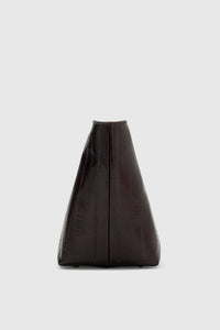 Side ghost view CAMILLA AND MARC Poppy Eel Clutch in Burgundy eel‑embossed leather with ribbed gold hardware.