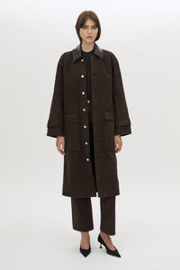 Styled view CAMILLA AND MARC Raha crew neck rib bodysuit in espresso brown with cap sleeve and ribbed neckline.