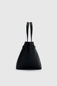 Side view CAMILLA AND MARC Willa Tote in Black with side strap and buckle detailing and magnetic button closure.