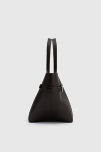 Side view CAMILLA AND MARC Willa Tote in Chocolate Brown with side strap and buckle detailing and magnetic button closure.