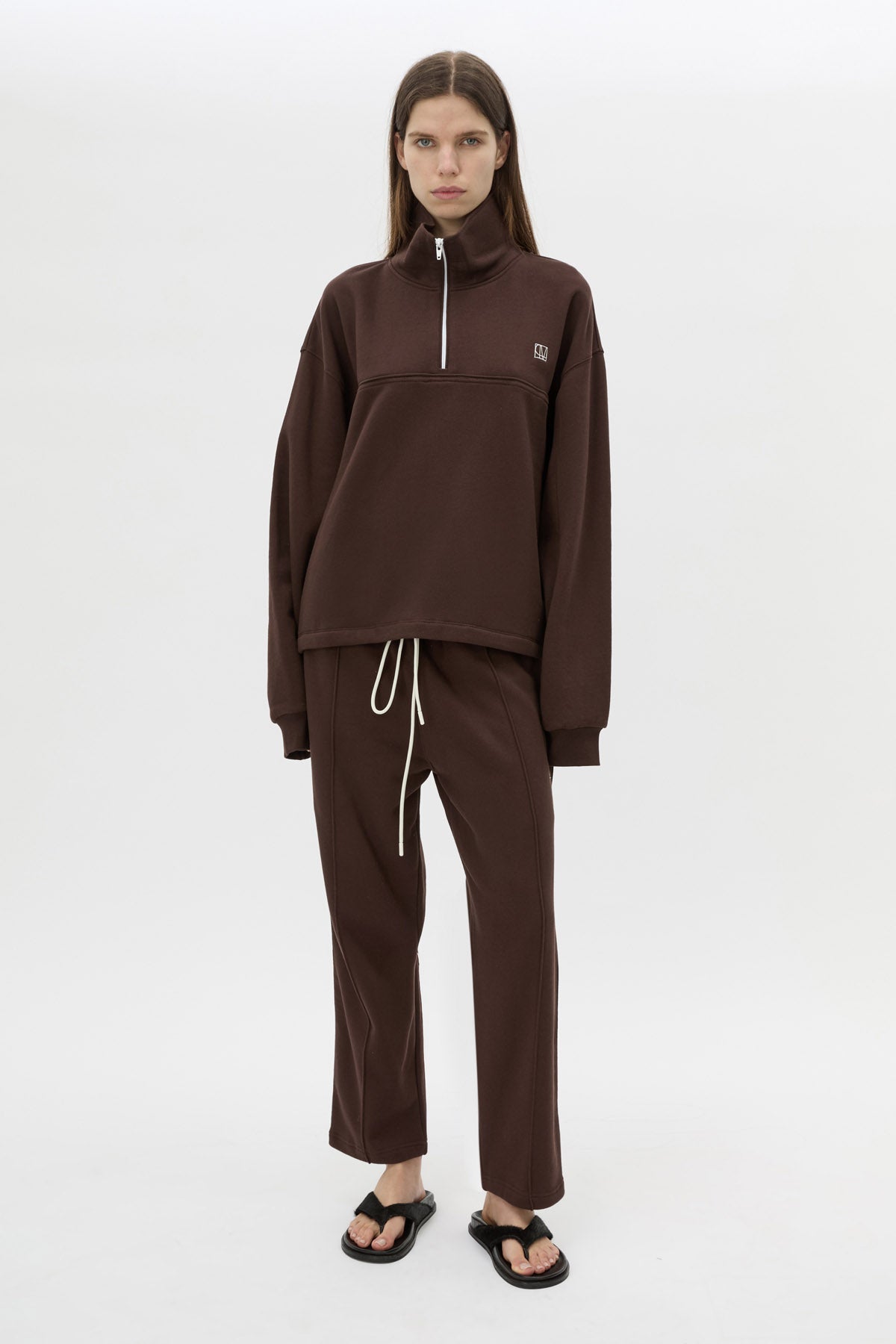 Styled view CAMILLA AND MARC Zylus straight-leg tracksuit pant in chocolate with embroidered monogram.